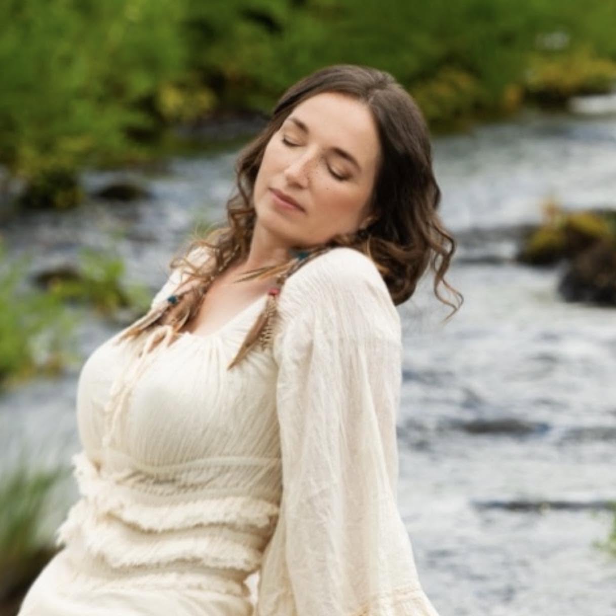 Tara Isis Gerris beside a flowing river