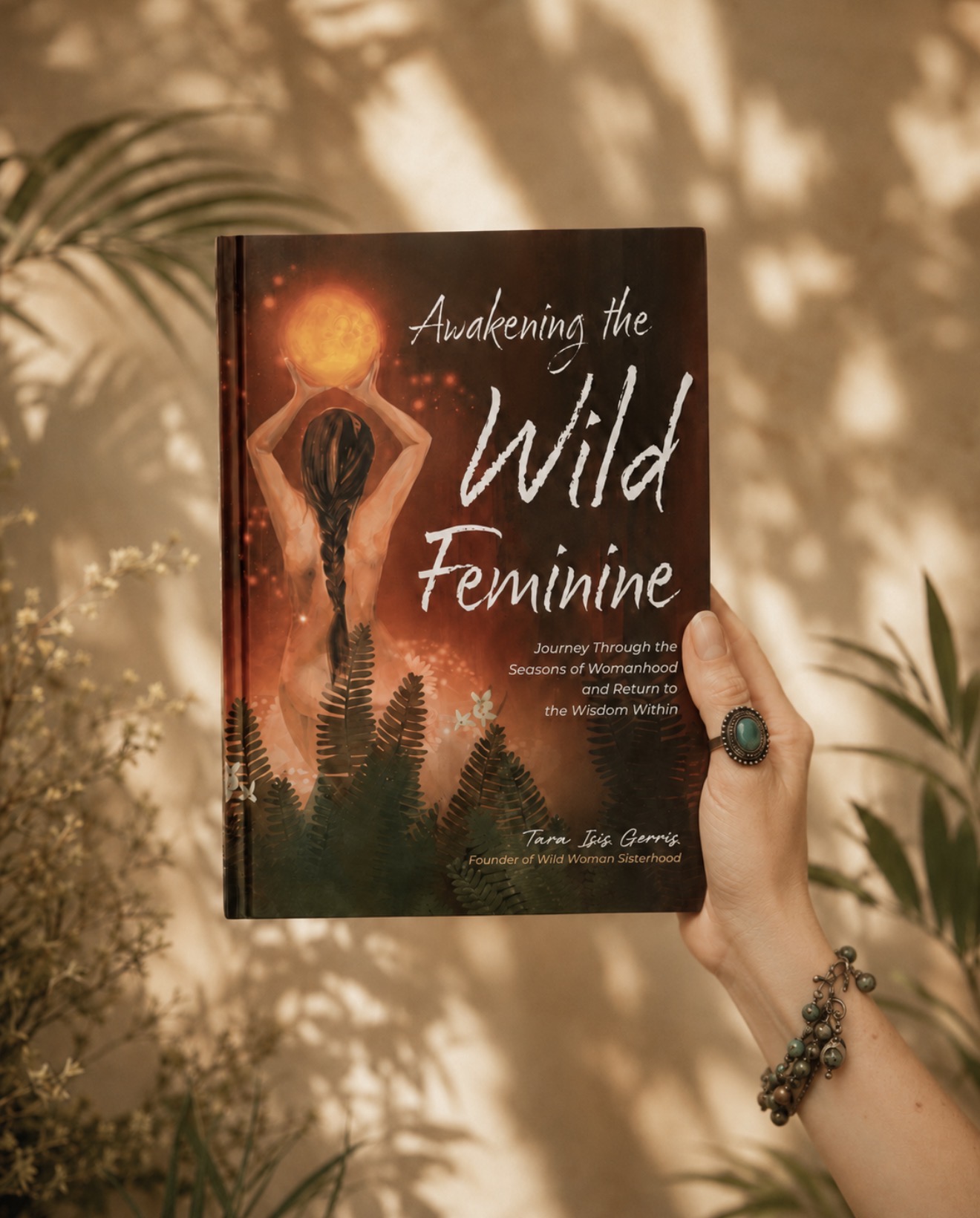 Tara Isis Gerris holding her book Awakening the Wild Feminine